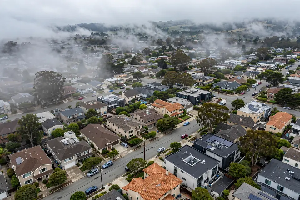 Aerial view of San Bruno, CA neighborhoods with varied residential rooftops